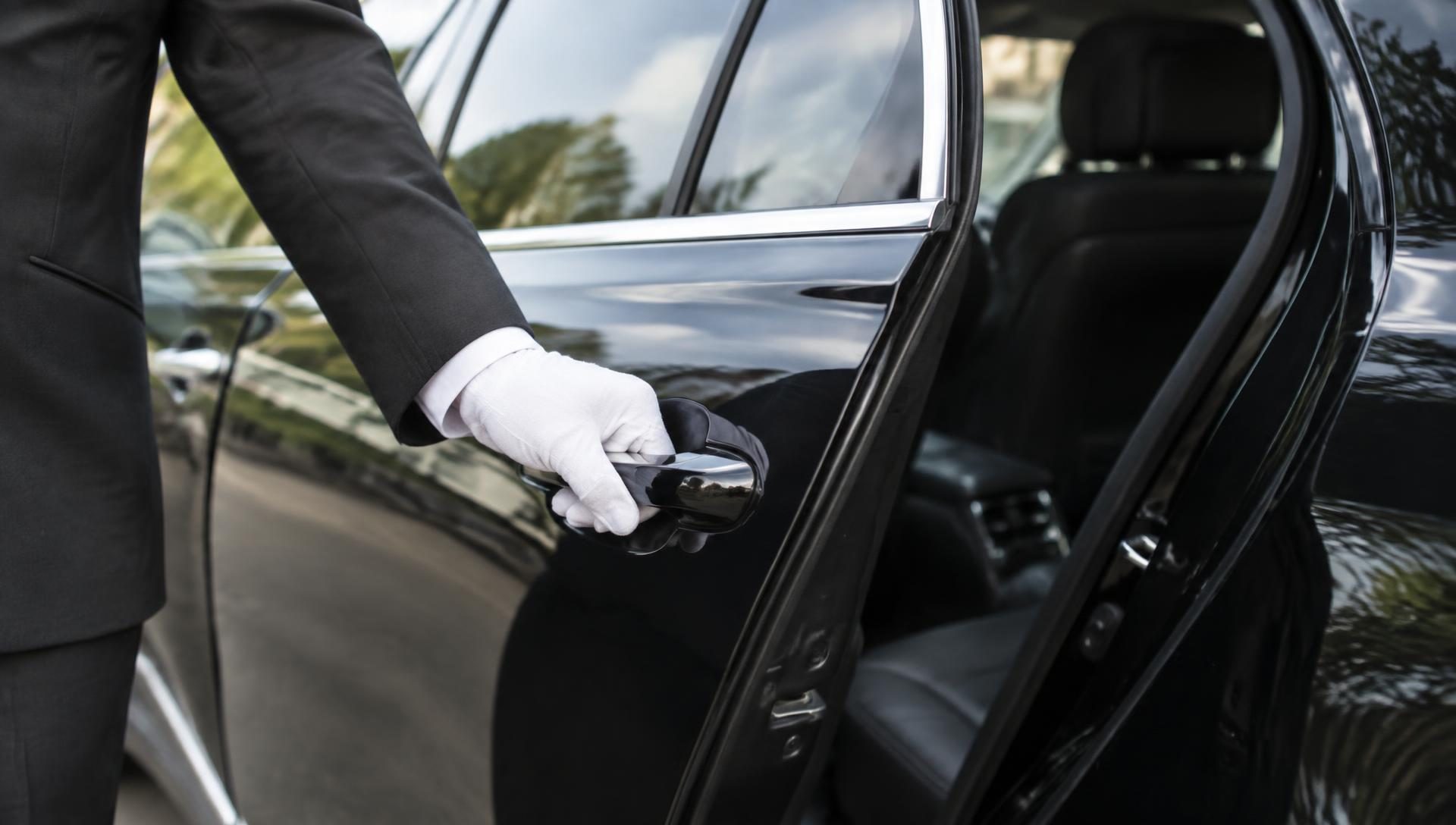 Chauffeur opening a car door