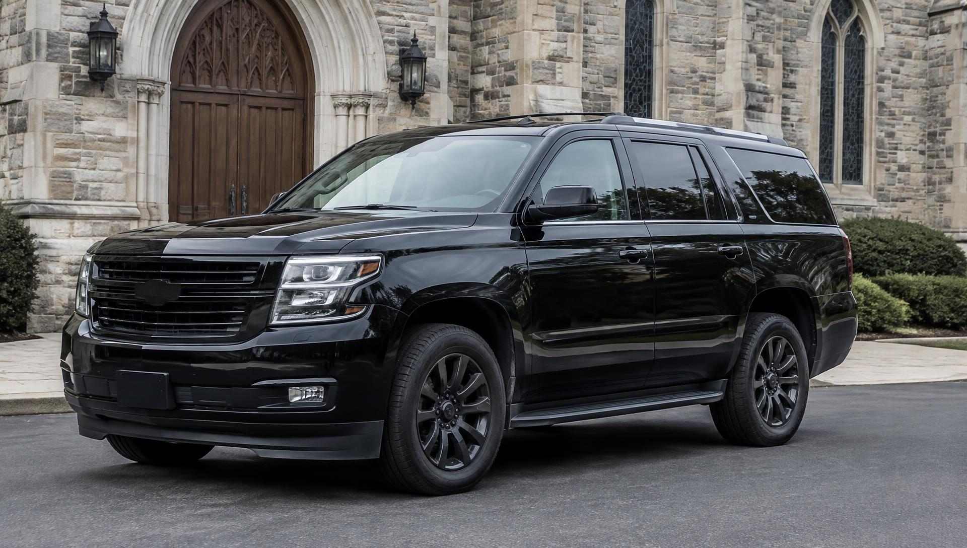 Black SUV parked outside a church entrance